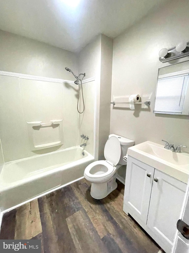 full bathroom with toilet, hardwood / wood-style flooring, shower / washtub combination, and vanity