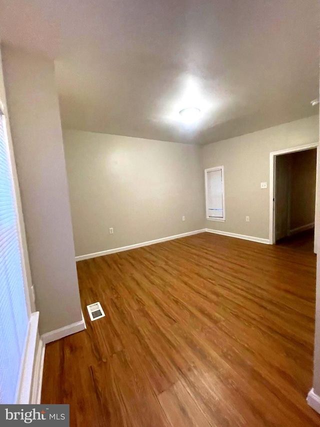 unfurnished room with wood-type flooring