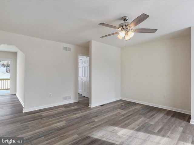 spare room with dark hardwood / wood-style flooring and ceiling fan