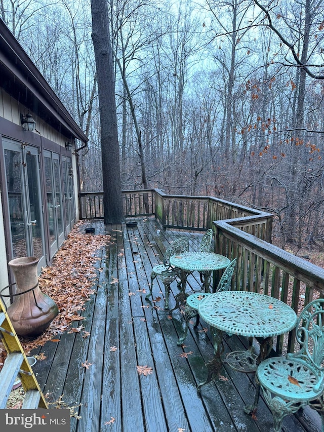 wooden deck with a sunroom