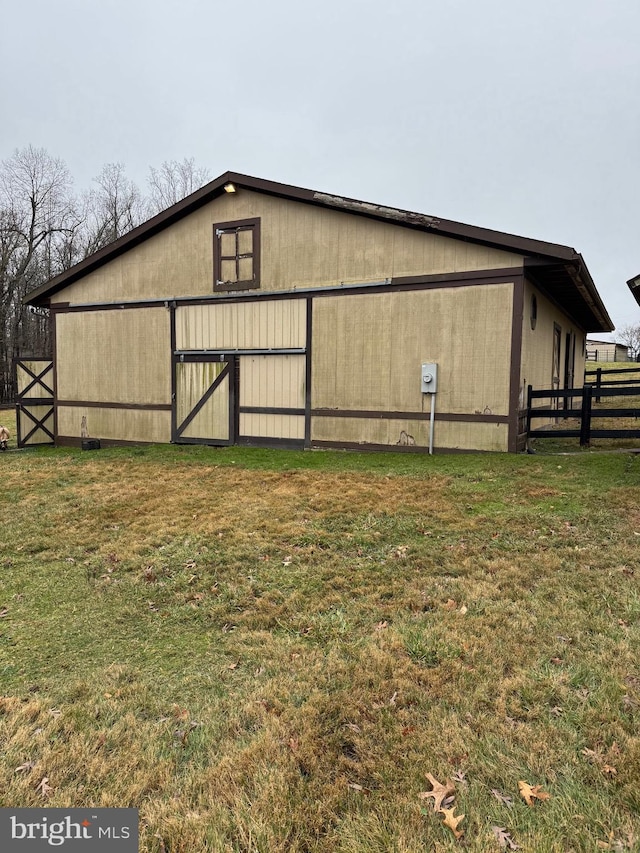 view of outbuilding with a yard