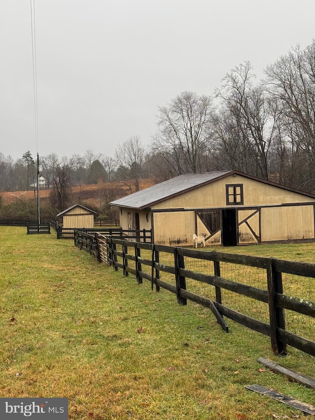 view of stable with a rural view