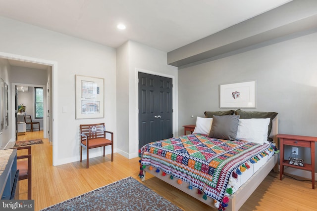 bedroom featuring hardwood / wood-style flooring and a closet