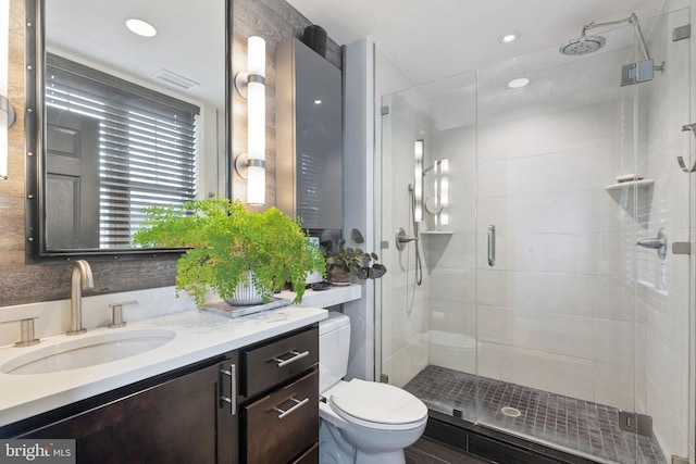 bathroom with vanity, toilet, and walk in shower