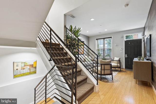 stairs featuring wood-type flooring