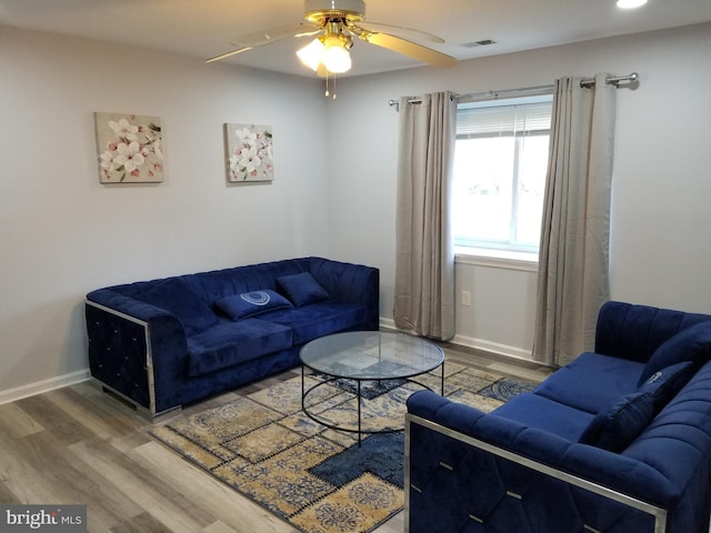 living room featuring hardwood / wood-style floors and ceiling fan