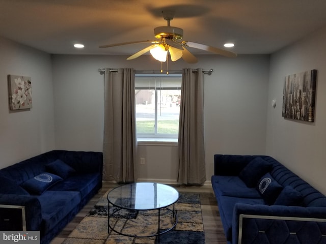 living room featuring ceiling fan and dark hardwood / wood-style flooring