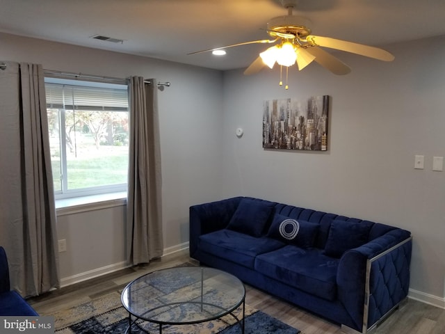 living room featuring ceiling fan and hardwood / wood-style flooring