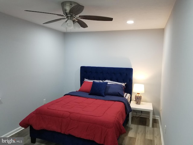 bedroom with hardwood / wood-style floors and ceiling fan