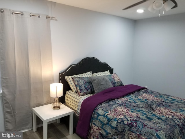 bedroom with ceiling fan and wood-type flooring