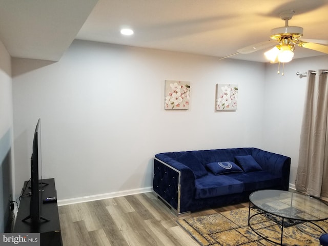 living room featuring ceiling fan and wood-type flooring