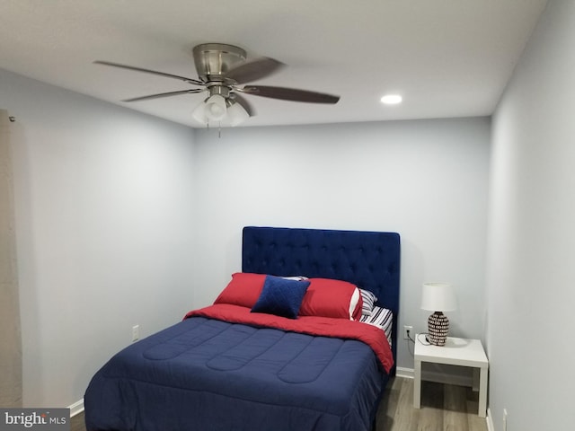 bedroom with ceiling fan and wood-type flooring