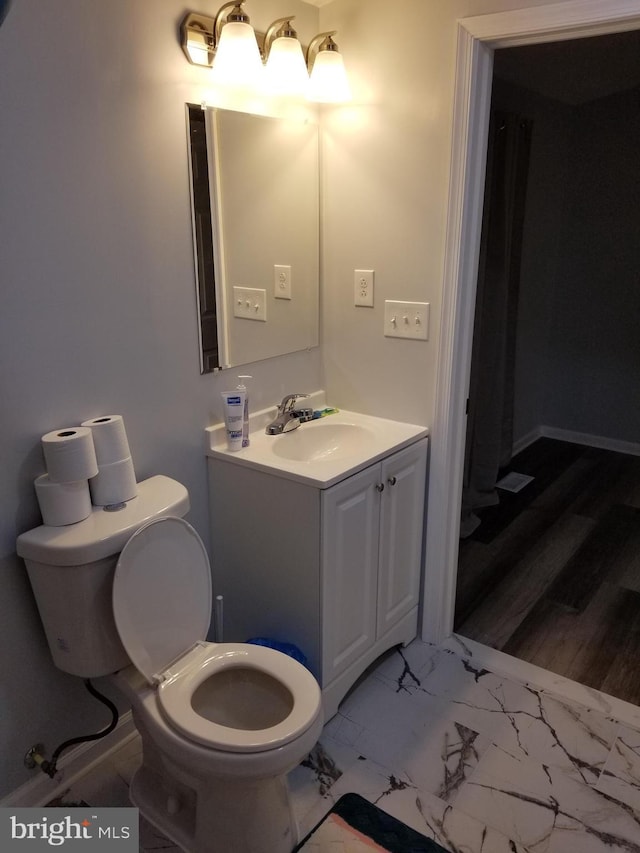 bathroom featuring vanity, toilet, and wood-type flooring