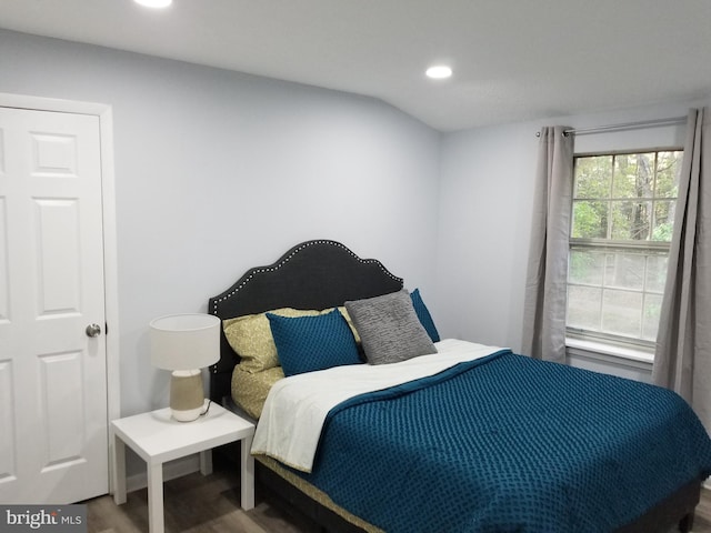 bedroom with hardwood / wood-style floors and vaulted ceiling