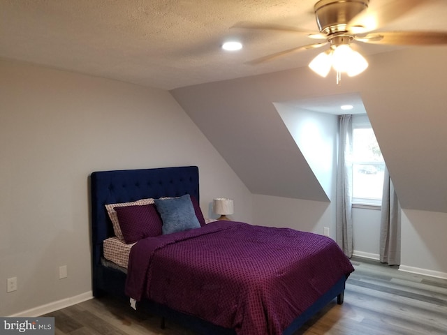 bedroom featuring a textured ceiling, ceiling fan, hardwood / wood-style floors, and lofted ceiling