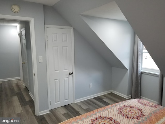 bonus room featuring dark wood-type flooring and lofted ceiling