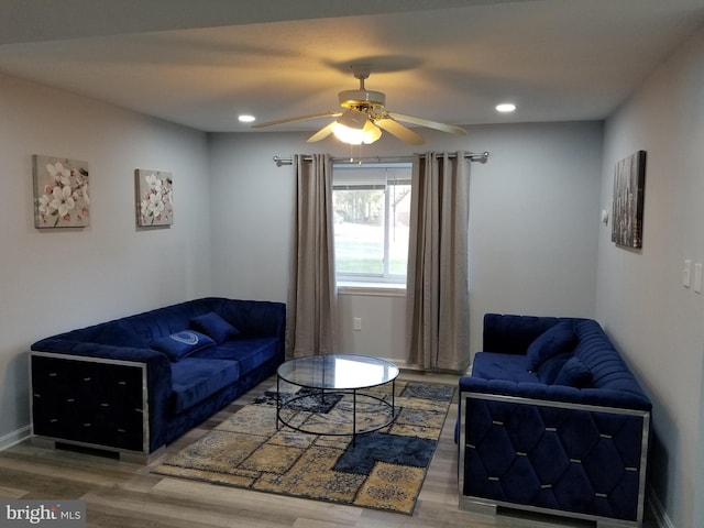 living room with dark hardwood / wood-style floors and ceiling fan