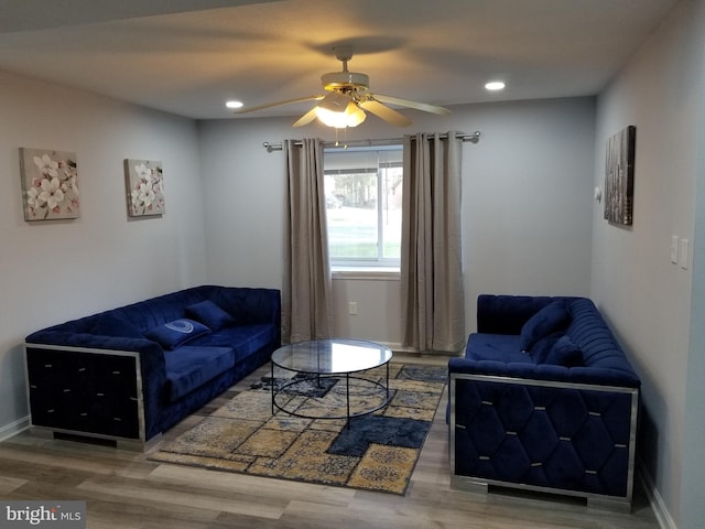 living room featuring ceiling fan and hardwood / wood-style floors