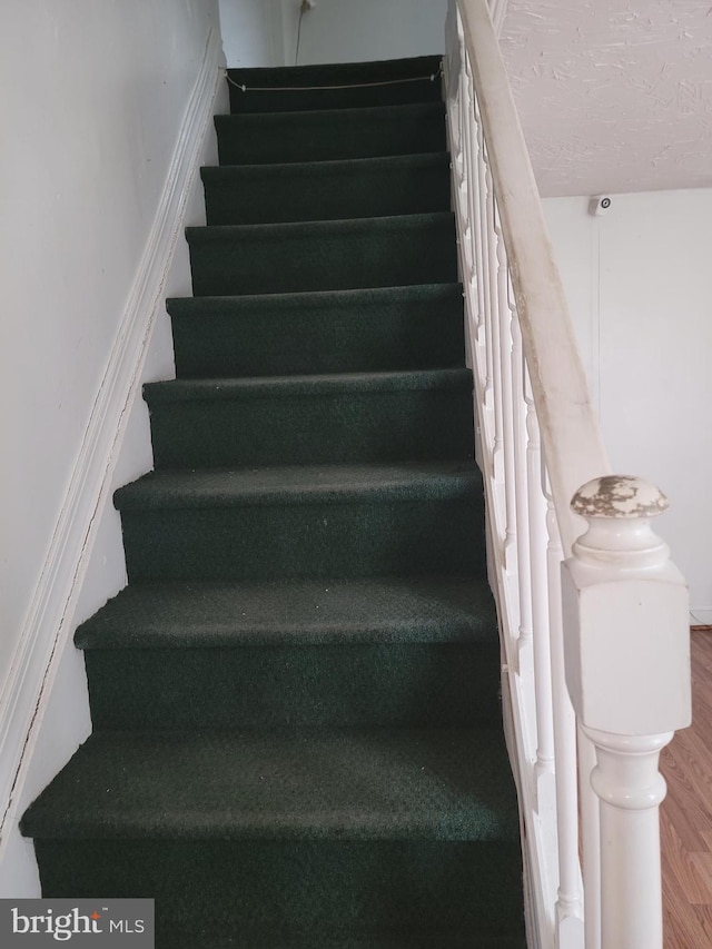 staircase featuring hardwood / wood-style flooring