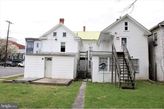 rear view of house with a lawn