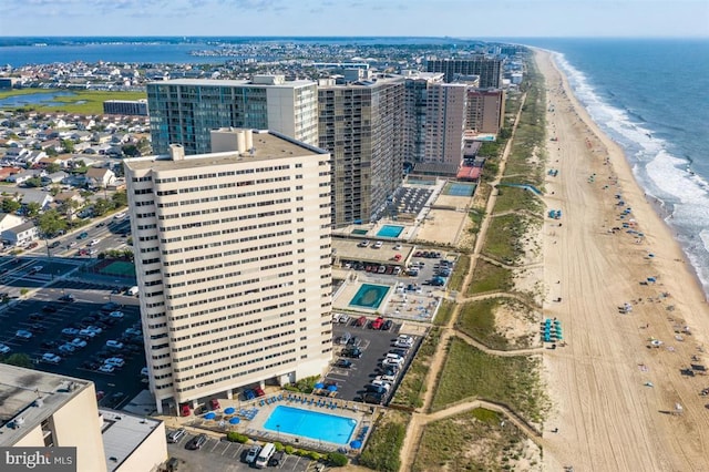 drone / aerial view with a water view and a view of the beach