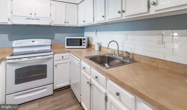 kitchen with white appliances, extractor fan, sink, dark hardwood / wood-style floors, and white cabinetry