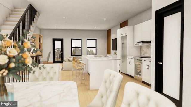 dining space featuring sink and light hardwood / wood-style flooring