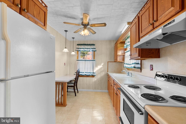 kitchen with ceiling fan, sink, hanging light fixtures, and white appliances