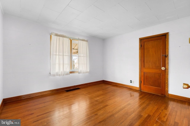 empty room with wood-type flooring