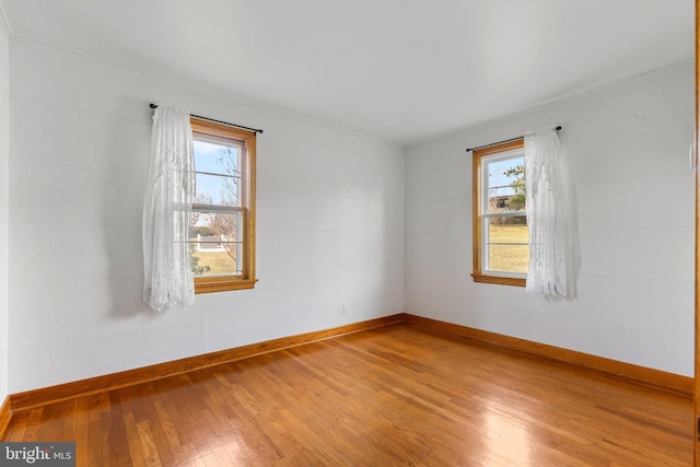 spare room with hardwood / wood-style flooring