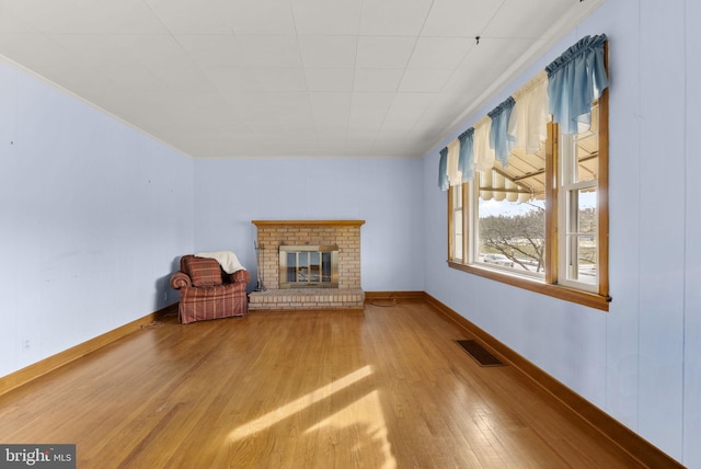 unfurnished room with a fireplace and hardwood / wood-style floors