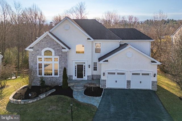 view of front facade with a garage and a lawn