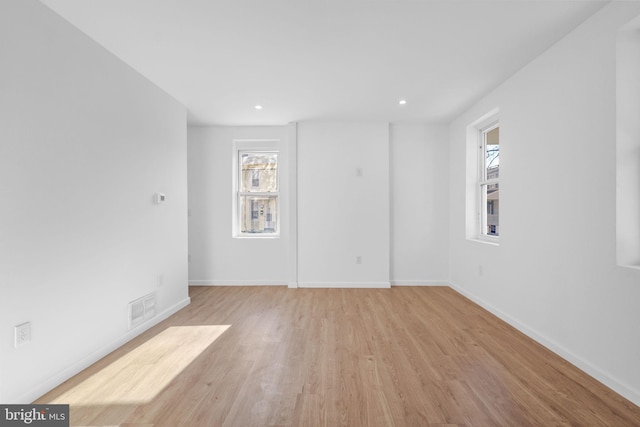 spare room with light hardwood / wood-style flooring