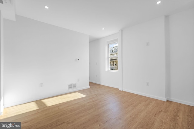 spare room featuring light hardwood / wood-style floors