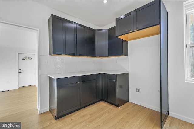 kitchen featuring light wood-type flooring and tasteful backsplash