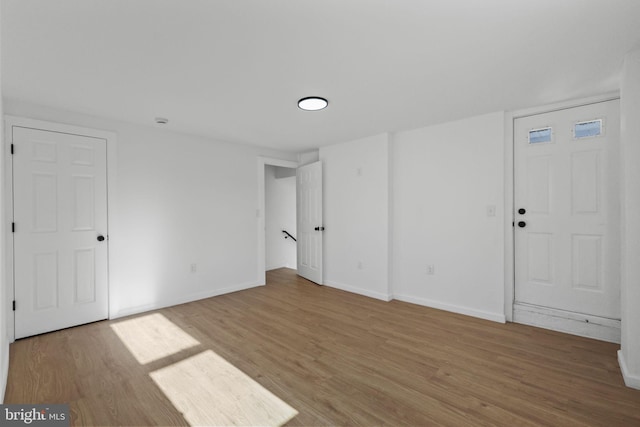 empty room with hardwood / wood-style flooring