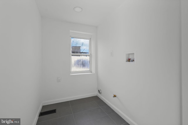 laundry room with gas dryer hookup, dark tile patterned floors, and hookup for a washing machine