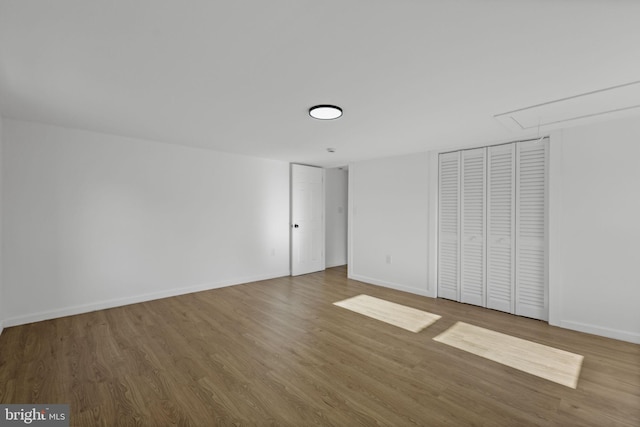 unfurnished bedroom featuring hardwood / wood-style floors and a closet