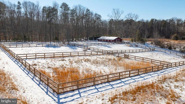 view of swimming pool with a rural view and an outdoor structure