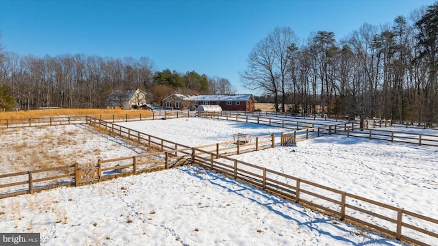 yard layered in snow featuring a rural view