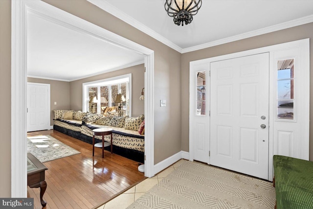 foyer entrance featuring ornamental molding and light hardwood / wood-style floors