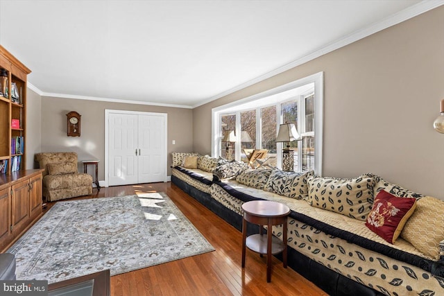 living room with wood-type flooring and crown molding