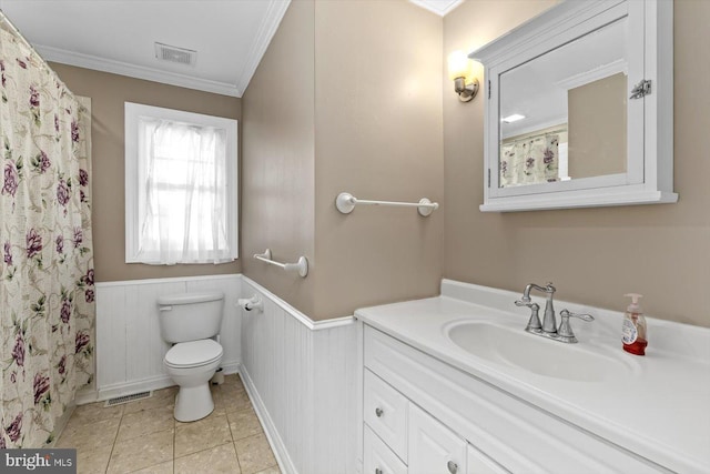 bathroom with toilet, vanity, tile patterned floors, and crown molding