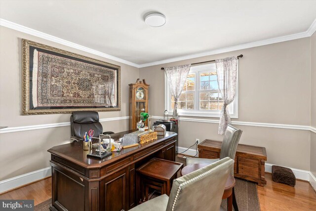 office space with ornamental molding and light hardwood / wood-style floors