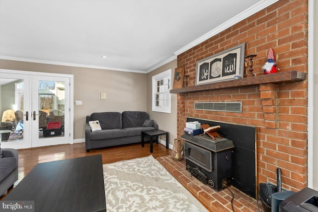 living room featuring hardwood / wood-style floors, crown molding, and french doors