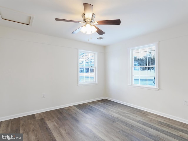 spare room featuring ceiling fan and dark hardwood / wood-style floors