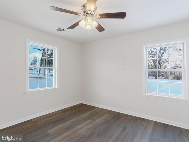 spare room featuring ceiling fan and dark hardwood / wood-style floors