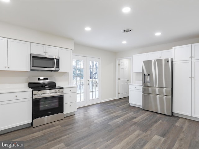 kitchen featuring dark wood-type flooring, white cabinets, and appliances with stainless steel finishes