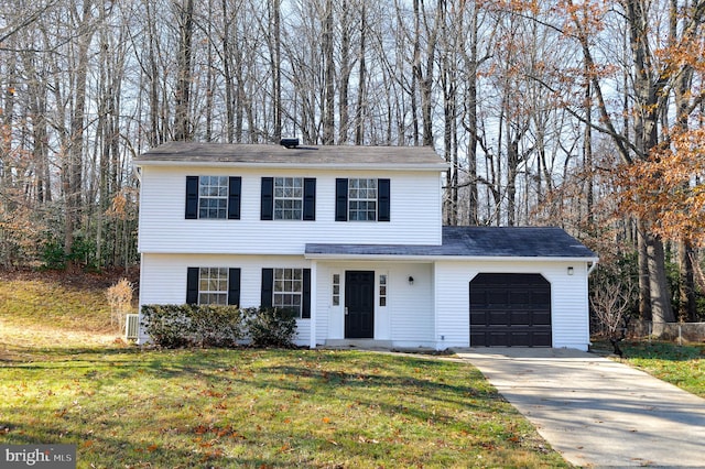 view of front of house with a front yard and a garage