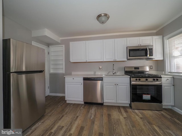 kitchen featuring crown molding, white cabinetry, dark hardwood / wood-style flooring, and stainless steel appliances